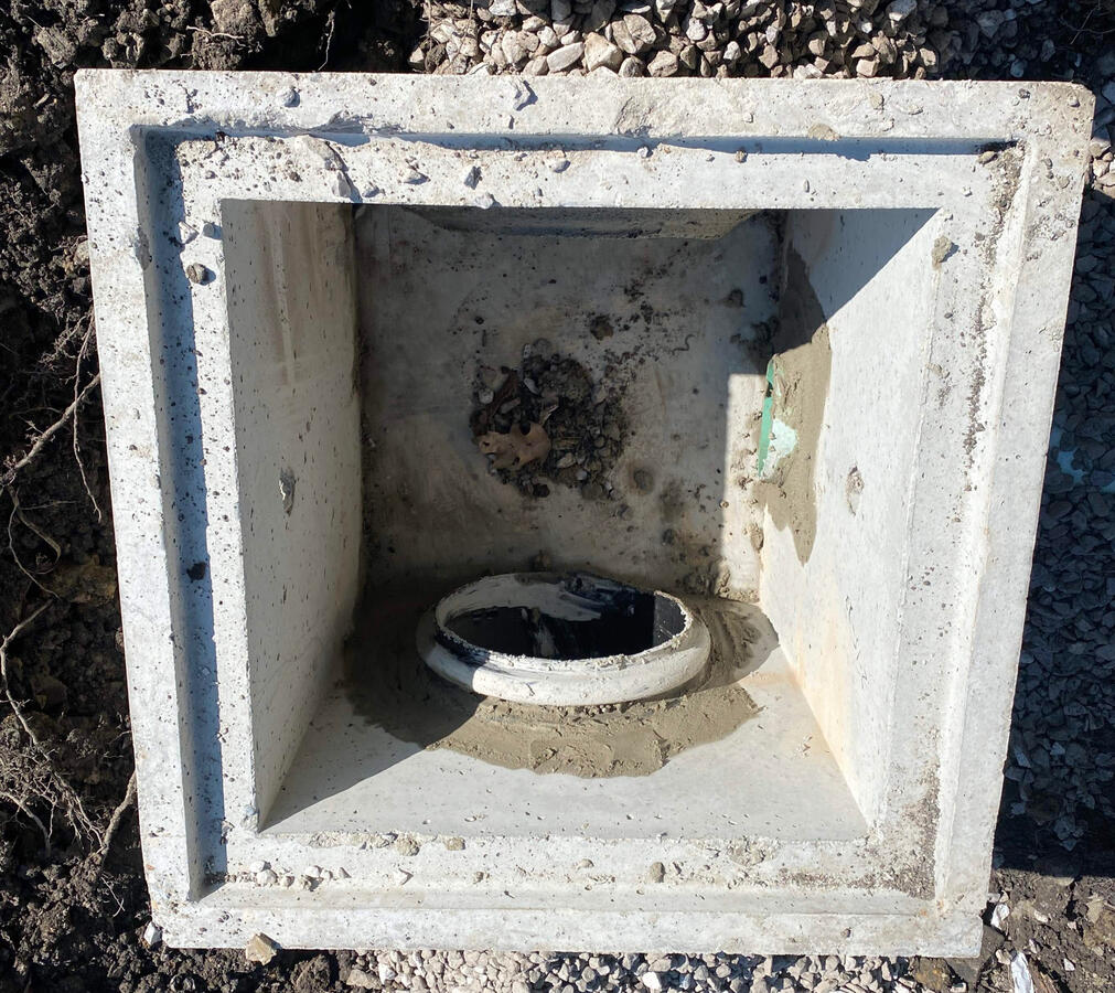 Fresh catch basin install with a 12 inch outlet pipe.